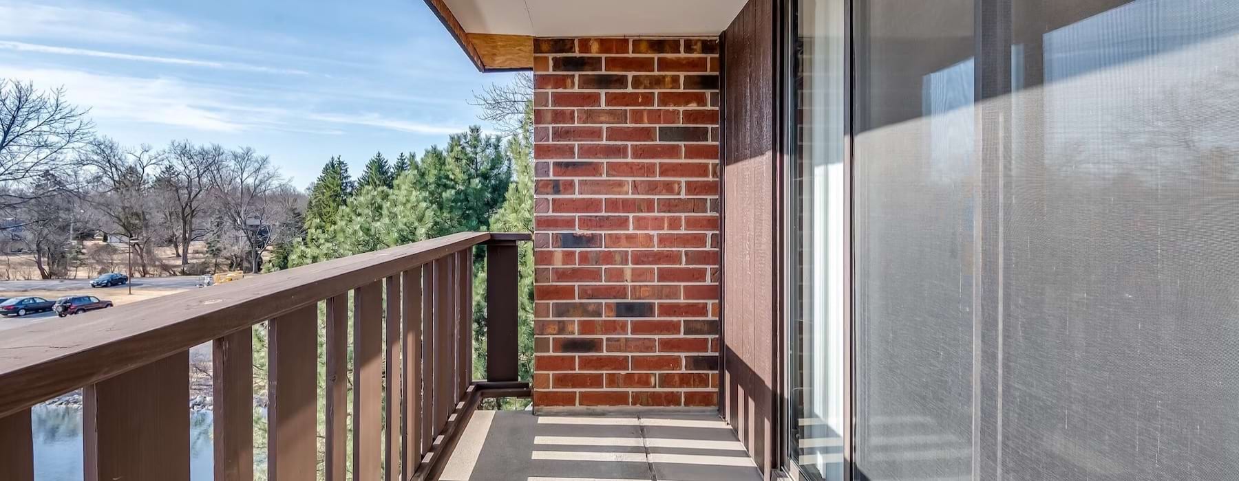 a balcony with a wood railing